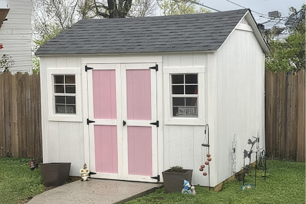 Custom studio with Hardie siding, sliding bard door, and transom windows